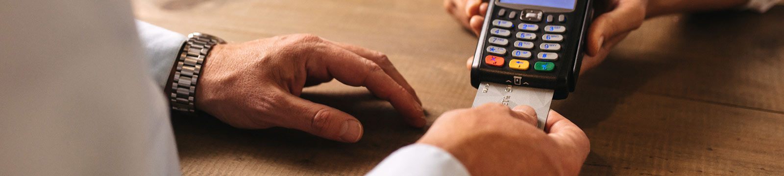 Man making payment with credit card reader.