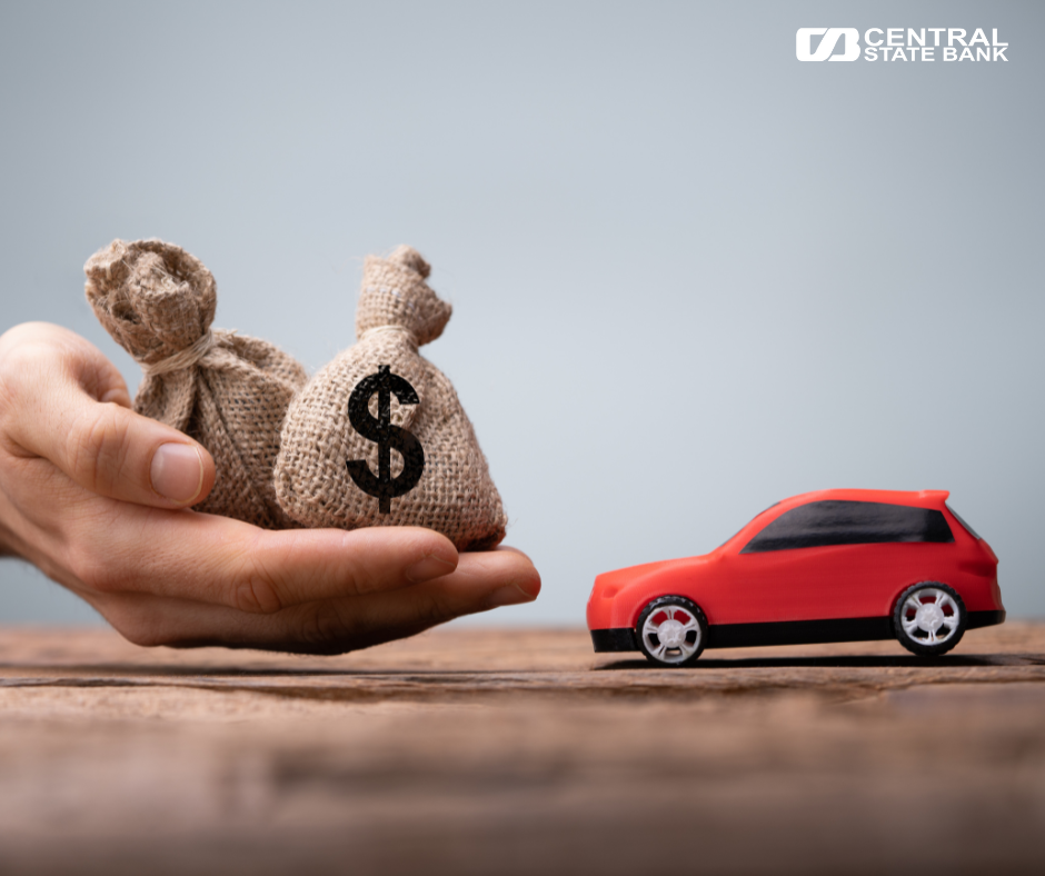 A picture with Central State Bank’s logo, a little toy car, and a hand carrying mini money bags.