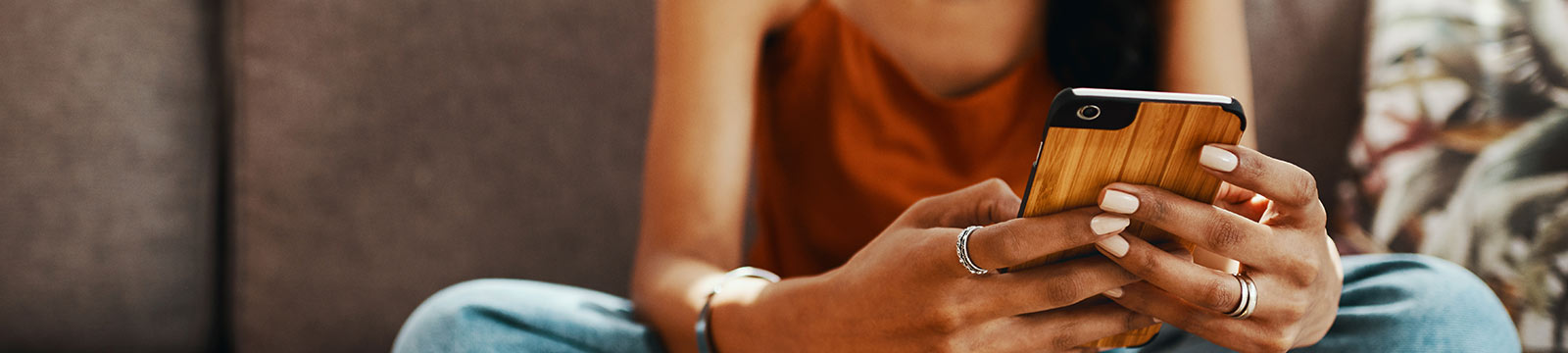 Woman holding phone on couch