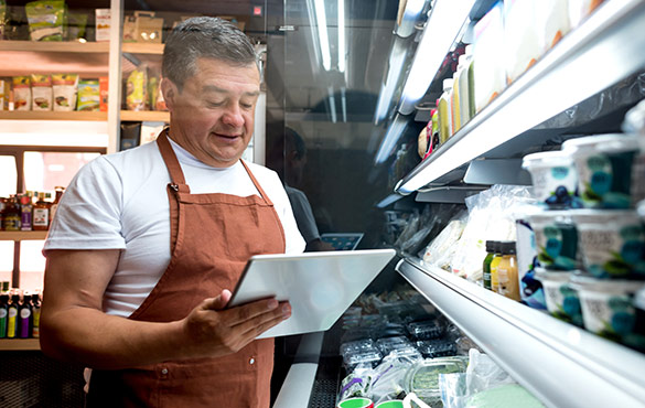 Man taking inventory of groceries at store.