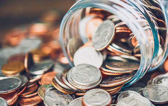 Coins spilling out of a jar.